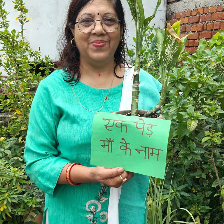 Teacher holding plant placard